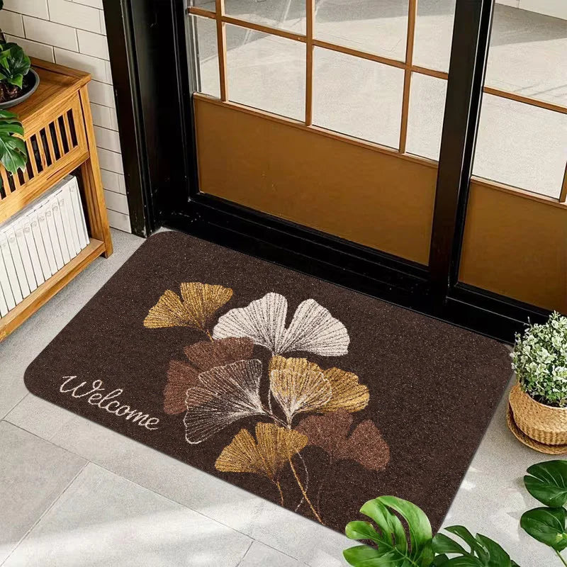 1 Piece, Dark Brown Base Flannel Floor Mat with Elegant Retro Style Gold, White, and Brown Ginkgo Leaf Patterns, with a Delicate and Eye-Catching White Grass Sign 'Welcome' on the Left. the Perfect Fusion of Natural Elements