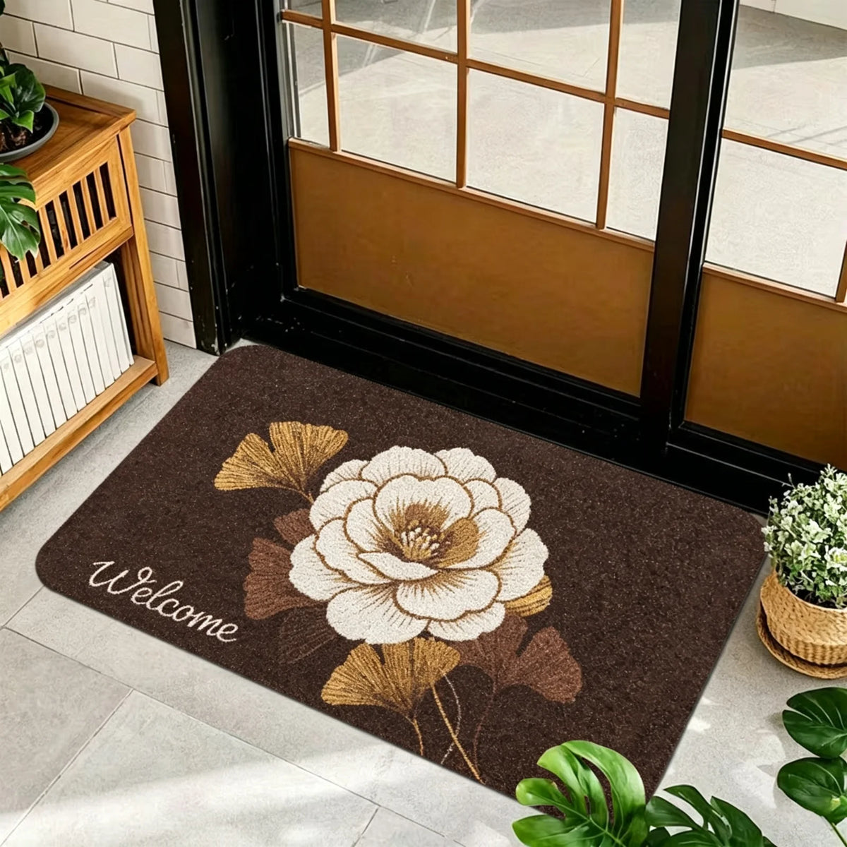 1 Piece, Dark Brown Base Flannel Floor Mat with Elegant Retro Style Gold, White, and Brown Ginkgo Leaf Patterns, with a Delicate and Eye-Catching White Grass Sign 'Welcome' on the Left. the Perfect Fusion of Natural Elements