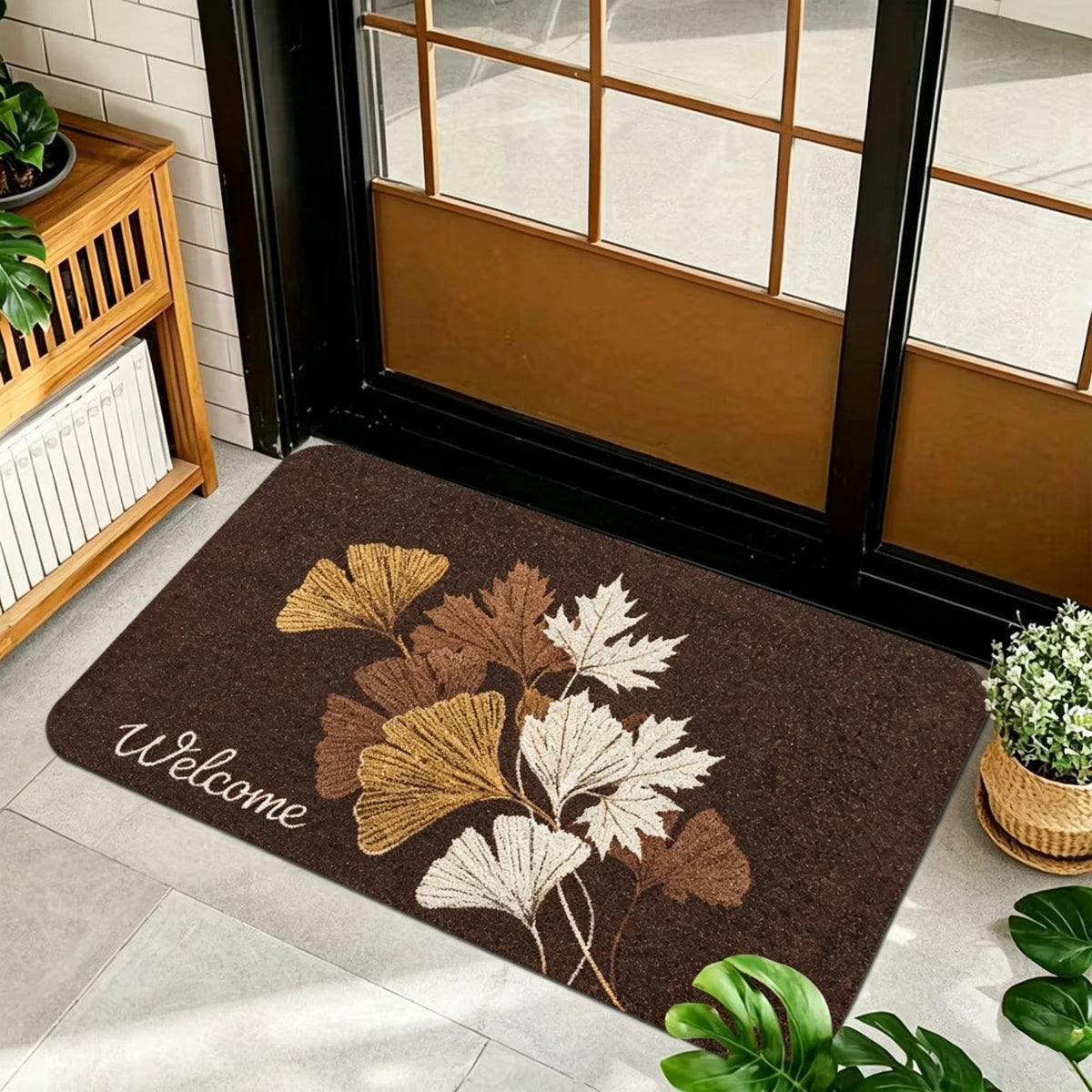 1 Piece, Dark Brown Base Flannel Floor Mat with Elegant Retro Style Gold, White, and Brown Ginkgo Leaf Patterns, with a Delicate and Eye-Catching White Grass Sign 'Welcome' on the Left. the Perfect Fusion of Natural Elements